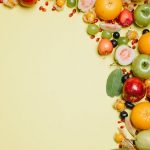 A vegetarian diet plan featuring colorful fruits and vegetables on a yellow background.