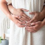 Person touching person's belly